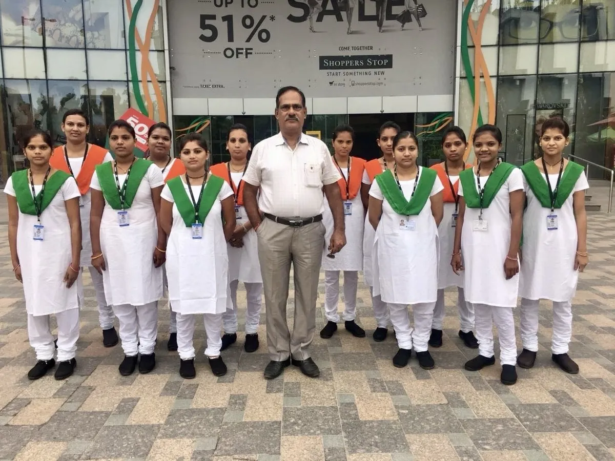 Global King female security guards deployed at a retail site in Ahmedabad, pictured with their site supervisor